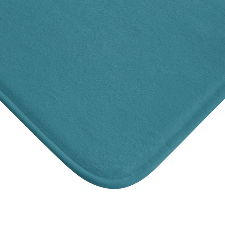 Close up of corner of teal bath mat