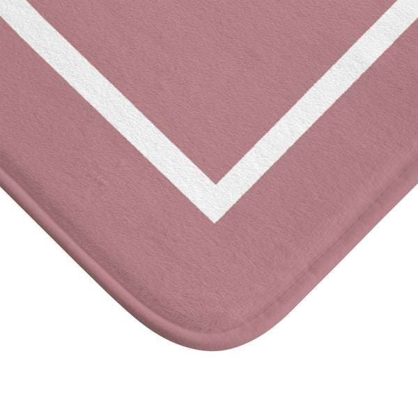 corner of pink and white bath mat