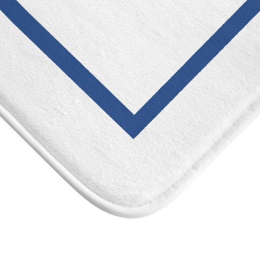 Close up of luxurious white bath mat with blue rectangle