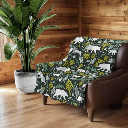 green and white fleece blanket with woodland animals pattern