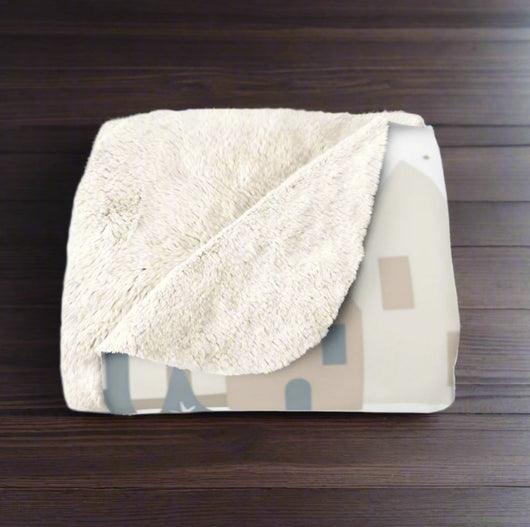 scandi  fleece throw blanket on a wooden floor