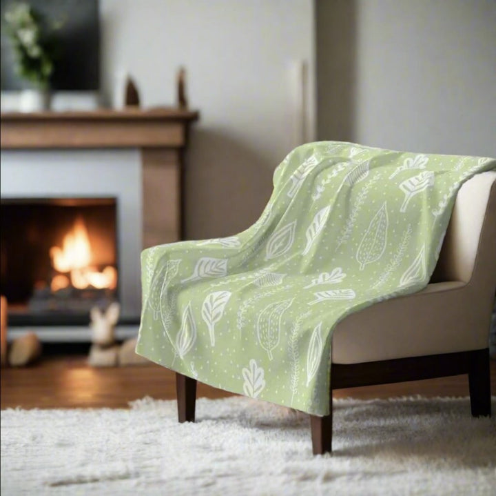 green decorative fleece  throw blanket with white leaf pattern