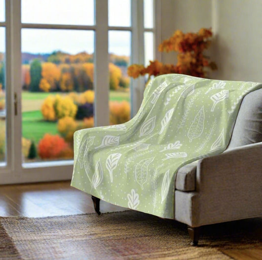 green fleece throw blanket in chair with fall view