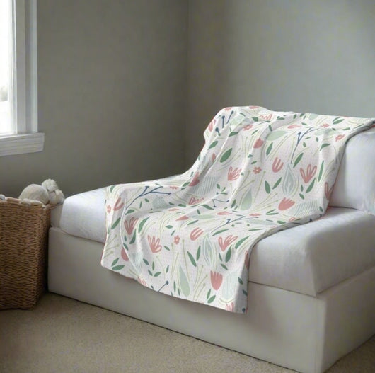 pink and green floral throw blanket on a sofa bed