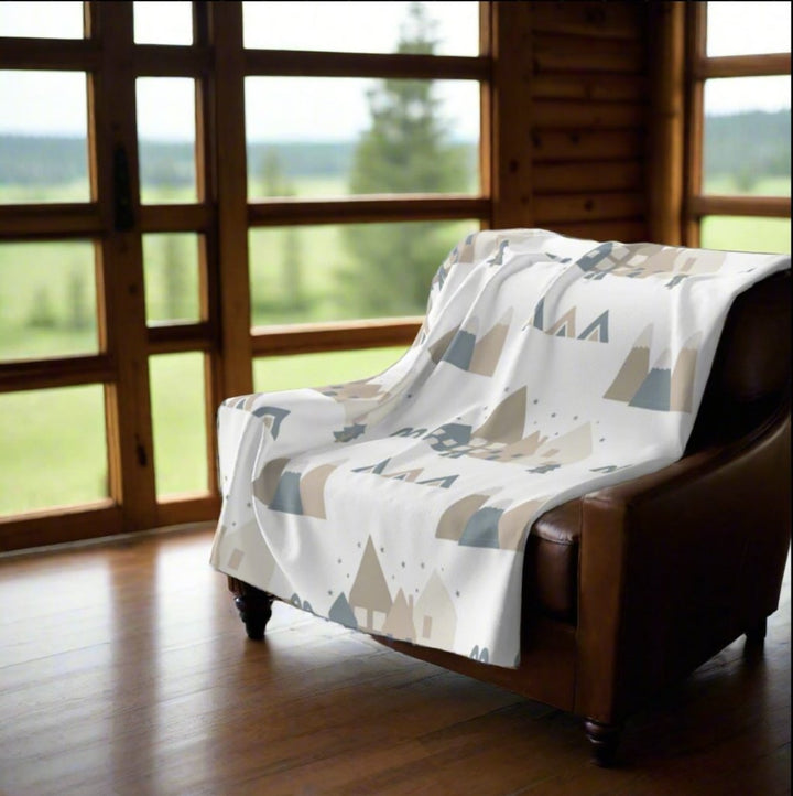 scandi fleece blanket on a leather chair in an elegant chalet with great view