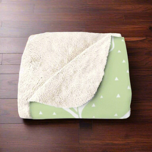 Natural Green Leaves Sherpa Fleece Blanket on dark wooden floor