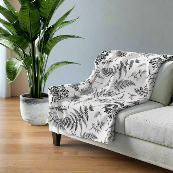 white throw banket with black fern design